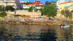 a couple of people on a boat in the water at Apartments Ranko in Zavalatica