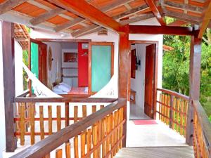 a porch of a house with a wooden railing at Pousada Meu Sossego in Barra Grande