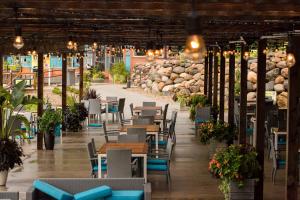 a restaurant with tables and chairs and lights and rocks at Bridges Bay Resort in Arnolds Park