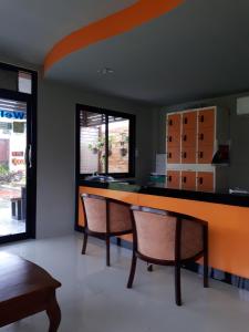 a dining room with a table and two chairs at Phi Phi Coralbay in Phi Phi Islands