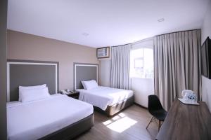 Tempat tidur dalam kamar di S Hotel & Residences