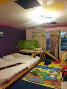 冬山鄉的住宿－101親子溜滑梯民宿 ，卧室配有两张双层床和地毯。