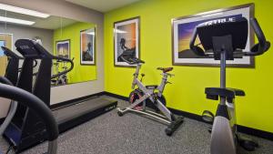 a gym with a treadmill and a bike in a room at Best Western Central City in Central City