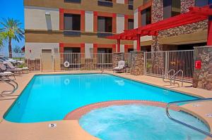 a swimming pool in front of a hotel at Legacy Inn & Suites in Mesa