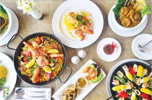 a table topped with plates of food and bowls of food at Villa Ibarra in Tagaytay