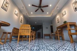 a room with chairs and a ceiling fan at The Besavana Phuket - SHA Extra Plus in Phuket Town