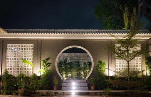 a building with an arched window and plants at The Besavana Phuket - SHA Extra Plus in Phuket Town