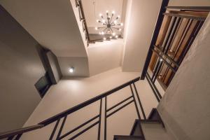a stairway with a chandelier in a building at The Besavana Phuket - SHA Extra Plus in Phuket Town