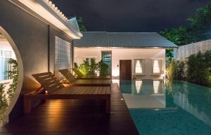 a villa with a swimming pool at night at The Besavana Phuket - SHA Extra Plus in Phuket Town