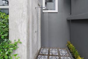 a shower stall with a mosaic floor in a garden at The Besavana Phuket - SHA Extra Plus in Phuket Town
