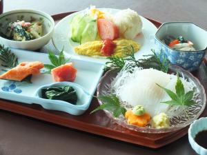 a tray with plates of food on a table at Seaside Hotel Kamome in Hakodate