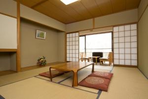 a living room with a table and a dining room at Kasuga no Mori in Saku