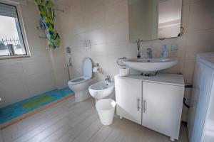 a bathroom with a toilet and a sink and a toilet istg at La Finestra sul Mare Locazione Turistica in Monte SantʼAngelo