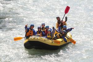 a group of people in a raft in the water at Baita Mas Socina in Peio