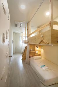 a room with two bunk beds and a hallway at Olle Stay in Seogwipo