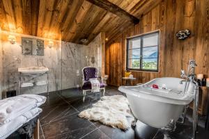 a large bathroom with a tub and a sink at La Belle Josephine in Bourg-Saint-Maurice