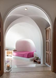 A bed or beds in a room at Perivolas Hotel