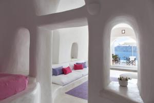 salon z białą kanapą i oknem w obiekcie Perivolas Hotel w mieście Oia +37 zdjęć