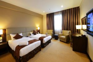 Ένα ή περισσότερα κρεβάτια σε δωμάτιο στο Lintas View Hotel