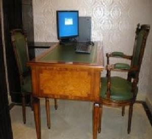 a wooden desk with a computer on top of it at Lander Hotel Prince Edward in Hong Kong