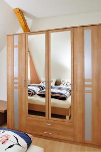 a wooden cabinet with two beds inside of it at Ferienwohnungen Conny in Rudolstadt