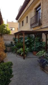 un patio con pergolato in legno accanto a un edificio di Apartamento de Lujo Av. Barber a Toledo