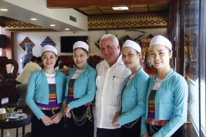 a man standing next to a group of chefs at Hoa Binh Hotel in Hòa Bình