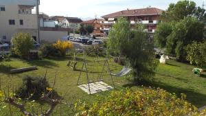 a swing set in a yard in a park at La Casa Zen in San Giovanni Teatino