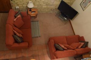 an overhead view of a living room with two chairs and a television at Swallows' Barn in Corby