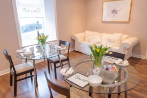 a living room with a table and a couch at Rooms at 31 in Stonehaven