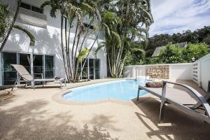 a swimming pool in front of a house at ViLLa JUNGLE 3 BEDROOMS in Kamala Beach