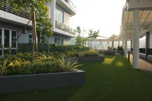 a courtyard of a building with green grass and plants at HomestayIpoh-Octagon in Ipoh