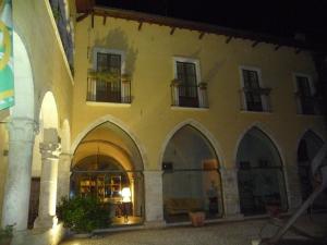 a large building with arches and windows at night at Grancia dei Celestini in Sulmona