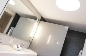 a bathroom with a sink and a mirror at Parkhotel Zug in Zug