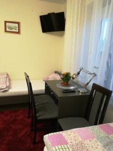 een kamer met een bed en een tafel en stoelen bij Pokoje Goscinne Lawenda II in Sandomierz
