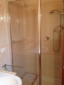 a shower with a glass door in a bathroom at Appartamento Family Park in Andalo