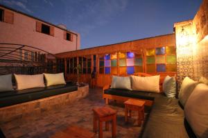 a patio with two couches and a table and chairs at Riad Les Chtis D'Agadir in Agadir