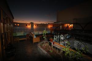 a room with a balcony with a couch and a table at Riad Les Chtis D'Agadir in Agadir