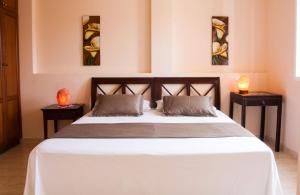 a bedroom with a large bed with two night stands at Paradise Corralejo in Corralejo