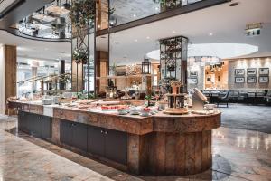 a restaurant with a large counter with food at Krumers Alpin – Your Mountain Oasis in Seefeld in Tirol