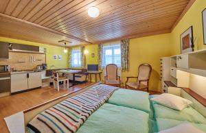 a bedroom with a large bed and a kitchen at Appartement Rainer in Saalbach Hinterglemm