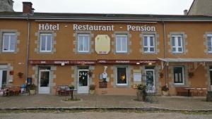 a building with a hotel restaurant permission on the front at hotel le chatiague in Tence