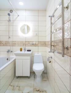 a bathroom with a toilet and a sink and a tub at "Indigo" in Kharkiv