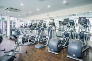 a gym with rows of treadmills and ellipticals at The Spa Hotel in Royal Tunbridge Wells