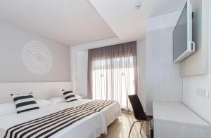 Ένα ή περισσότερα κρεβάτια σε δωμάτιο στο Hotel Oasis Park Splash
