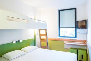 a bedroom with a bunk bed and a window at Ibis Budget Salzburg Airport - Self-Check-In in Salzburg
