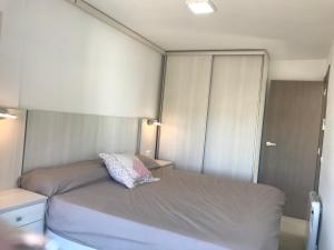 a bedroom with a bed with a pillow on it at First line Apartment in Alicante