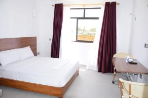 Ένα ή περισσότερα κρεβάτια σε δωμάτιο στο Mawenzi Resort -Mtwapa +13 φωτογραφίες