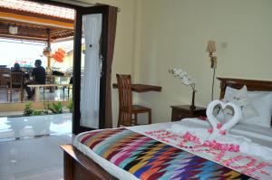 a bedroom with a bed with a heart decoration on it at Deva Devi Beach Inn Luxury in Nusa Penida