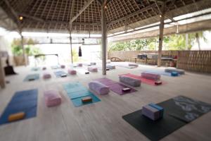 a large room with many yoga mats on the floor at Pondok Pisang Candidasa in Candidasa